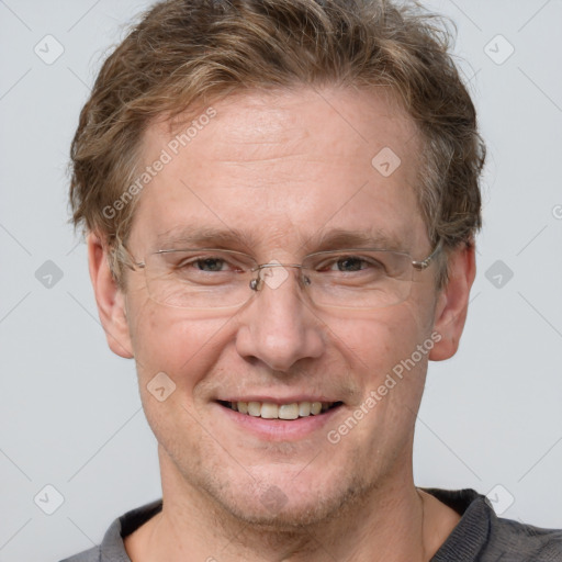 Joyful white adult male with short  brown hair and grey eyes