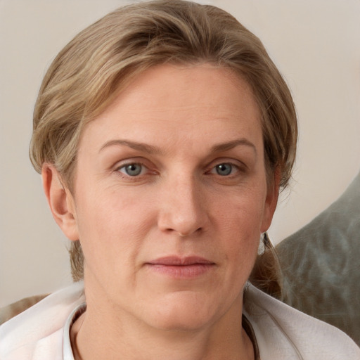 Joyful white adult female with medium  brown hair and grey eyes