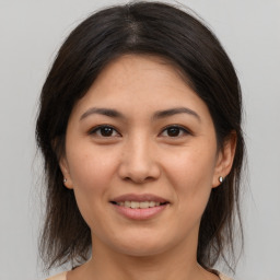 Joyful asian young-adult female with medium  brown hair and brown eyes