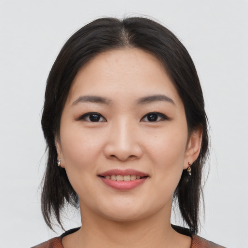 Joyful asian young-adult female with medium  black hair and brown eyes