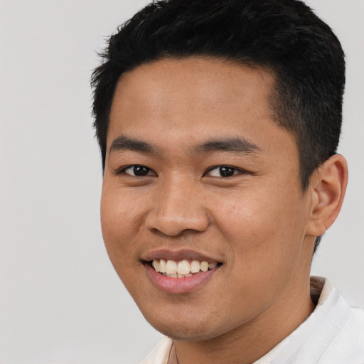 Joyful asian young-adult male with short  black hair and brown eyes