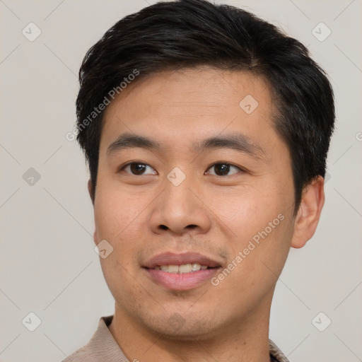 Joyful asian young-adult male with short  brown hair and brown eyes