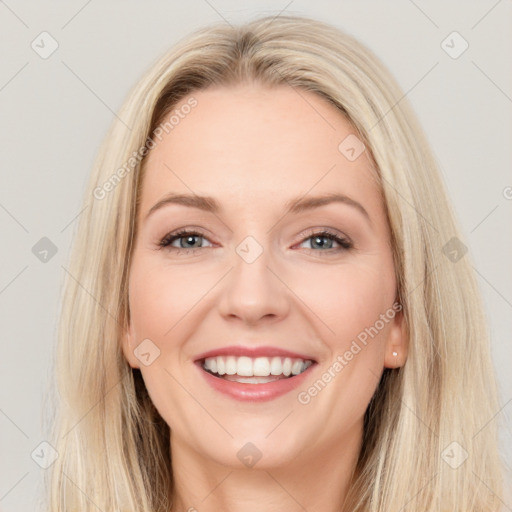 Joyful white young-adult female with long  brown hair and blue eyes