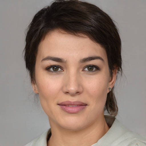 Joyful white young-adult female with medium  brown hair and brown eyes