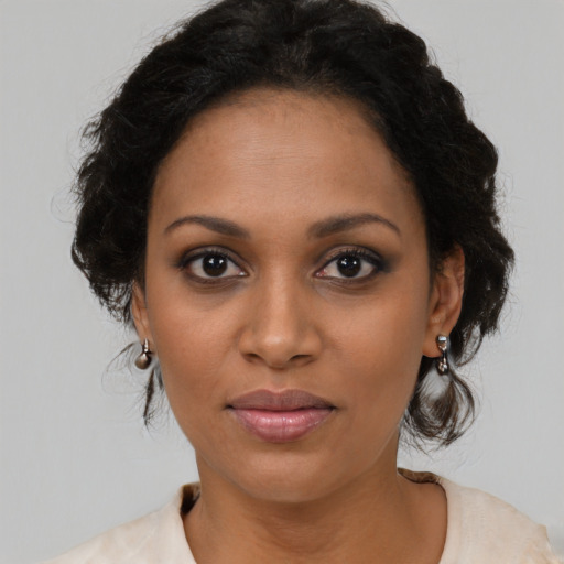 Joyful black young-adult female with medium  brown hair and brown eyes