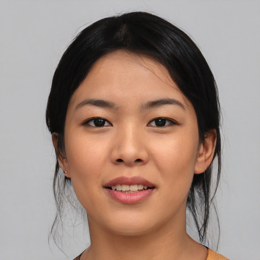 Joyful asian young-adult female with medium  black hair and brown eyes