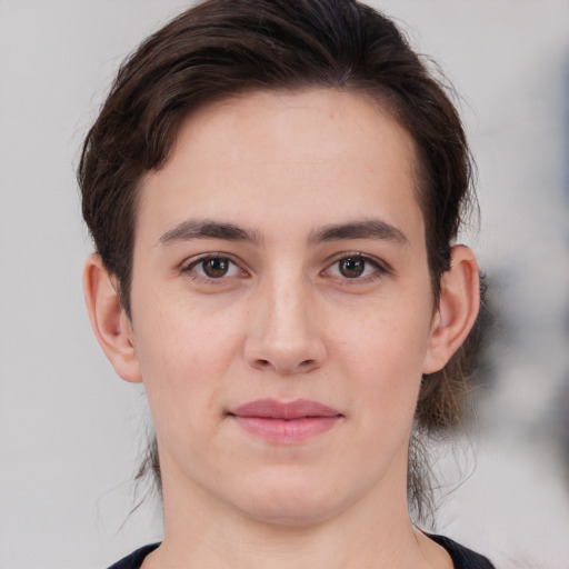 Joyful white young-adult female with medium  brown hair and brown eyes