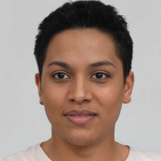 Joyful latino young-adult female with short  black hair and brown eyes