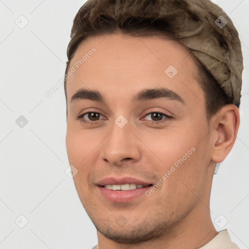 Joyful white young-adult male with short  brown hair and brown eyes