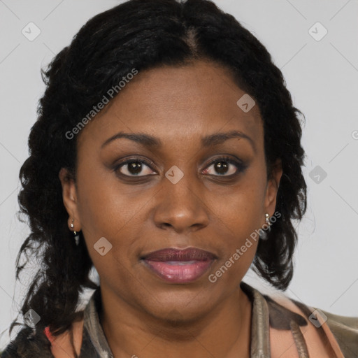 Joyful black adult female with long  brown hair and brown eyes
