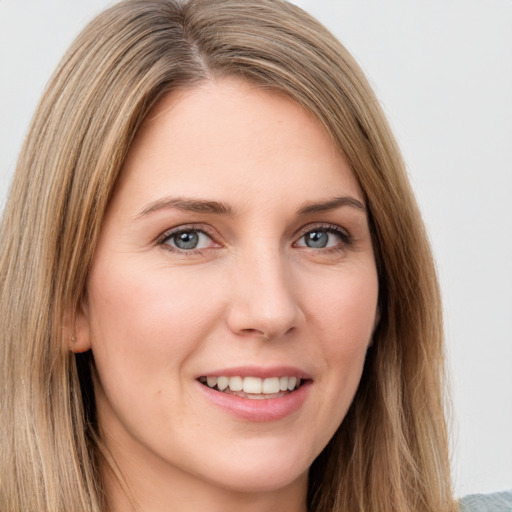 Joyful white young-adult female with long  brown hair and green eyes