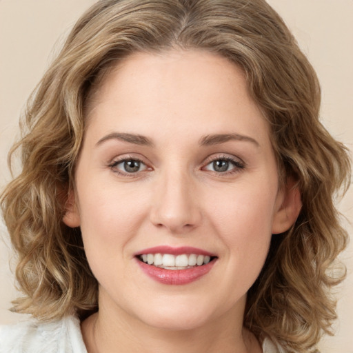 Joyful white young-adult female with medium  brown hair and green eyes