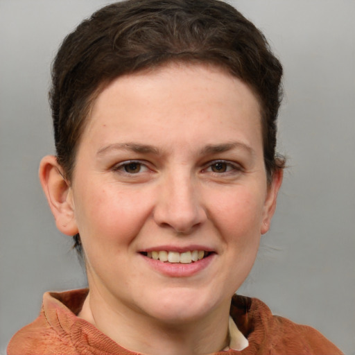 Joyful white young-adult female with short  brown hair and grey eyes