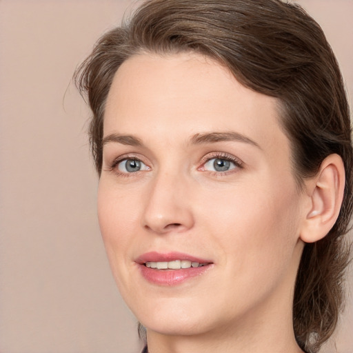 Joyful white adult female with medium  brown hair and grey eyes