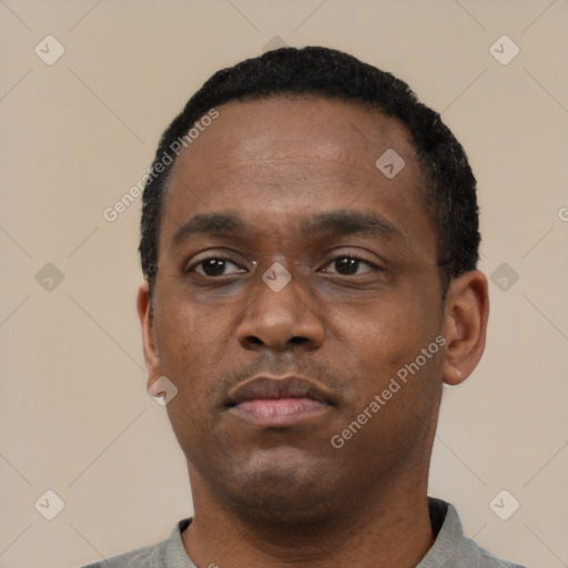 Neutral latino adult male with short  black hair and brown eyes