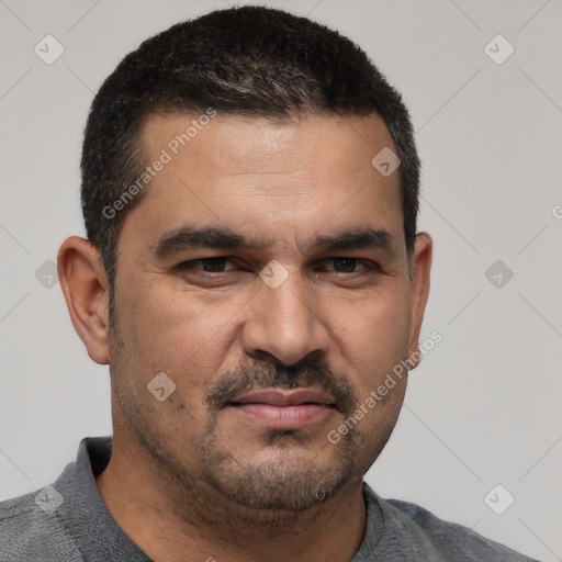 Joyful white adult male with short  black hair and brown eyes