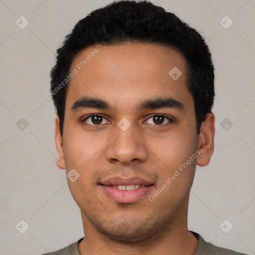 Joyful latino young-adult male with short  black hair and brown eyes