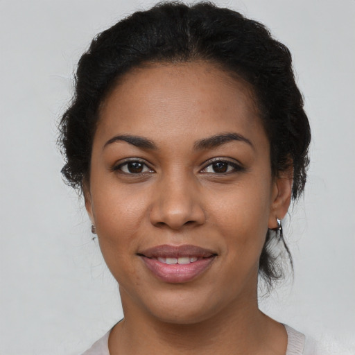 Joyful latino young-adult female with short  brown hair and brown eyes