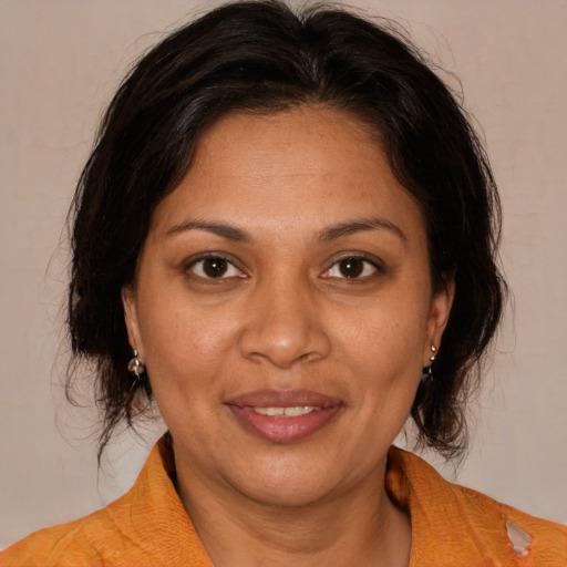 Joyful white adult female with medium  brown hair and brown eyes