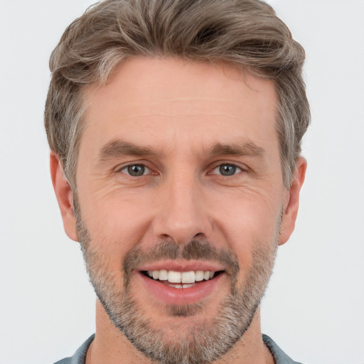 Joyful white adult male with short  brown hair and grey eyes