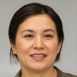 Joyful white adult female with medium  brown hair and brown eyes