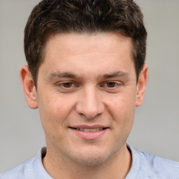 Joyful white adult male with short  brown hair and grey eyes