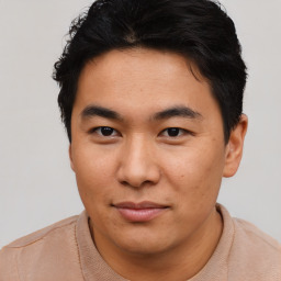 Joyful asian young-adult male with short  brown hair and brown eyes