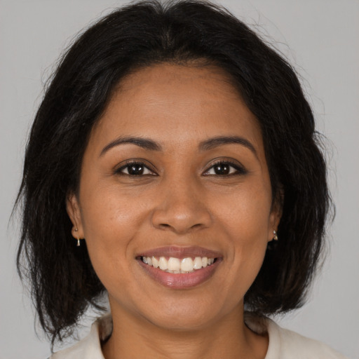 Joyful black young-adult female with medium  brown hair and brown eyes