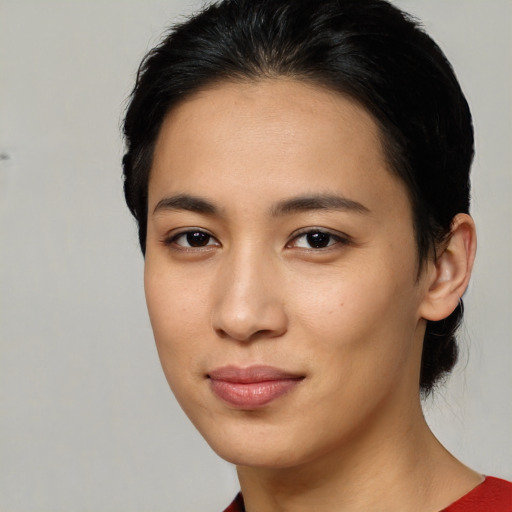 Joyful latino young-adult female with medium  brown hair and brown eyes