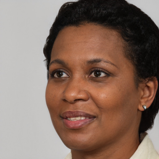 Joyful black adult female with short  brown hair and brown eyes