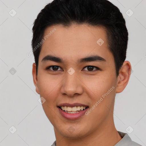 Joyful asian young-adult male with short  brown hair and brown eyes