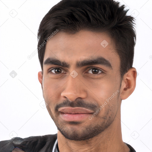 Joyful white young-adult male with short  black hair and brown eyes