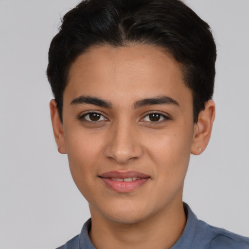 Joyful latino young-adult male with short  brown hair and brown eyes