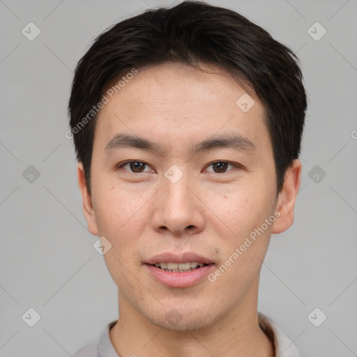 Joyful asian young-adult male with short  brown hair and brown eyes