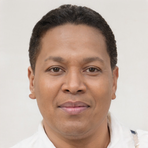 Joyful black adult male with short  brown hair and brown eyes