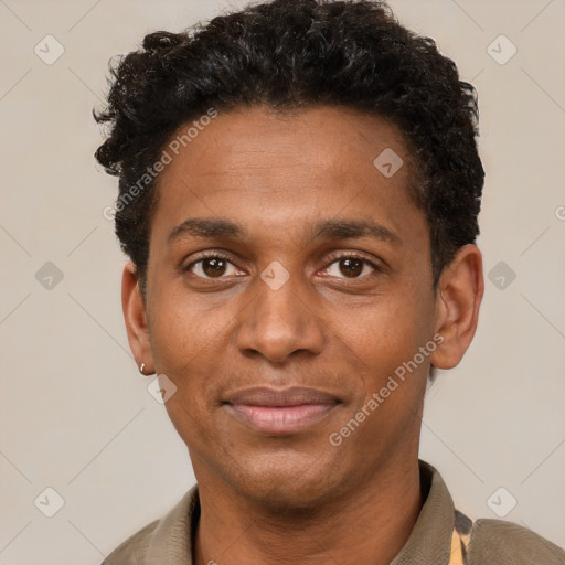 Joyful black young-adult male with short  brown hair and brown eyes