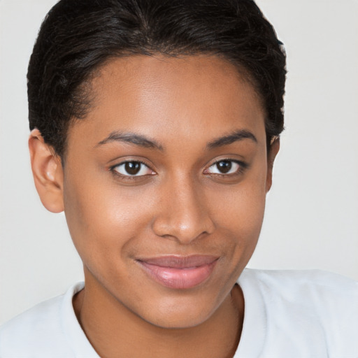 Joyful black young-adult female with short  brown hair and brown eyes