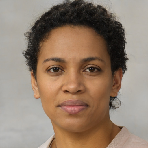 Joyful black young-adult female with short  brown hair and brown eyes