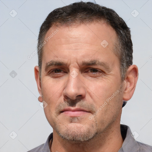 Joyful white adult male with short  brown hair and brown eyes