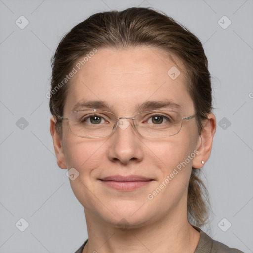 Joyful white adult female with medium  brown hair and grey eyes