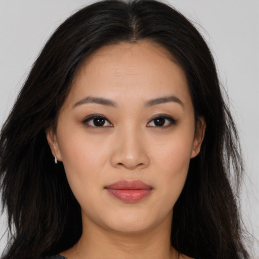 Joyful asian young-adult female with long  black hair and brown eyes