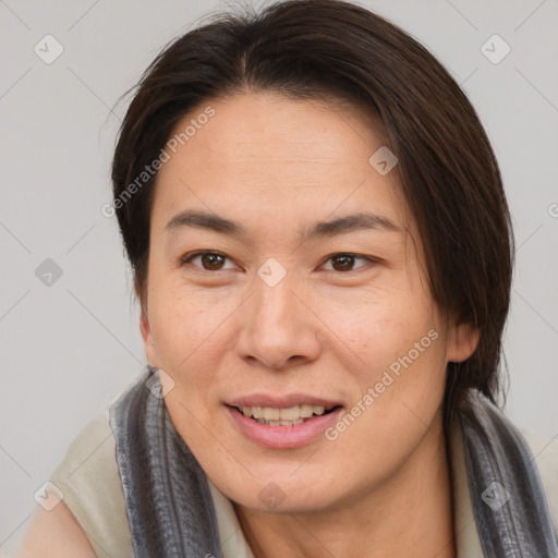 Joyful asian young-adult female with medium  brown hair and brown eyes