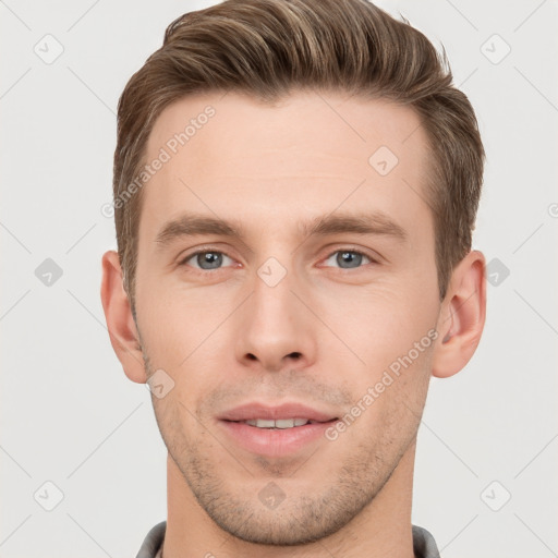 Joyful white young-adult male with short  brown hair and grey eyes