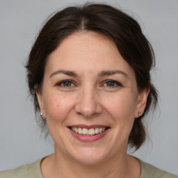 Joyful white adult female with medium  brown hair and brown eyes