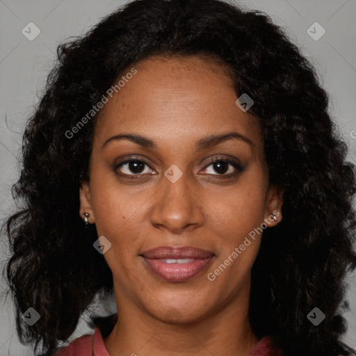 Joyful black adult female with long  brown hair and brown eyes