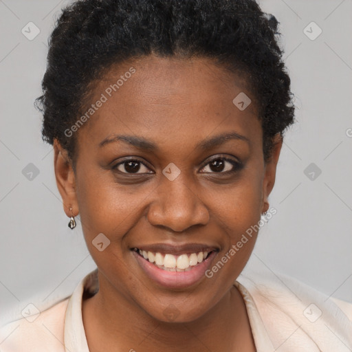 Joyful black young-adult female with short  brown hair and brown eyes