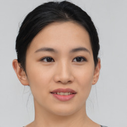 Joyful asian young-adult female with medium  black hair and brown eyes