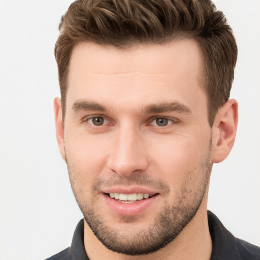 Joyful white young-adult male with short  brown hair and brown eyes