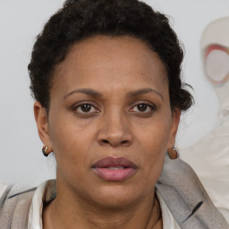 Joyful black adult female with short  brown hair and brown eyes