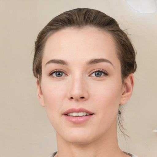 Joyful white young-adult female with short  brown hair and grey eyes